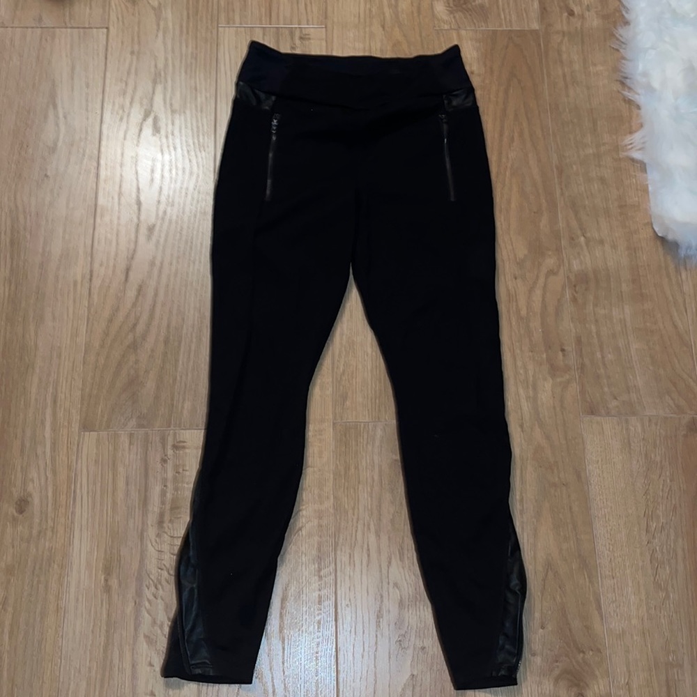 Athleta women’s black leggings with leather details and a zipper